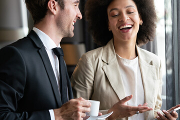 Poster - Two young businesspeople having a successful meeting at restaurant.