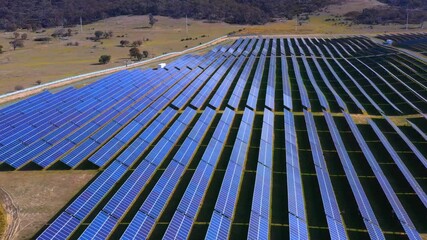 Wall Mural - dolly aerial view shot of a large solar farm for renewable energy supply in canberra, australia