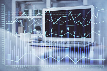 Financial chart drawing and table with computer on background. Multi exposure. Concept of international markets.