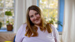 © TommyStockProject - Portrait of beautiful overweight young woman looking at camera at home interior