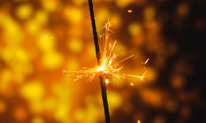 Wall Mural - Banner festive photo of sparkler on bright festive christmas background