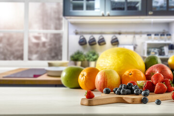 Wall Mural - Fresh fruit in the kitchen on a wooden table by the sunny window