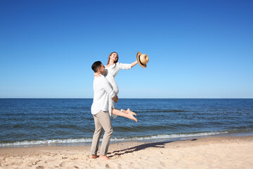 Wall Mural - Lovely couple having fun on sea beach