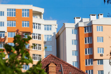 New tall apartment buildings with brown roof of a house. Residential architecture