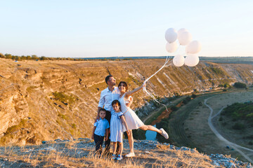 Canvas Print - happy family with balloons at sunset