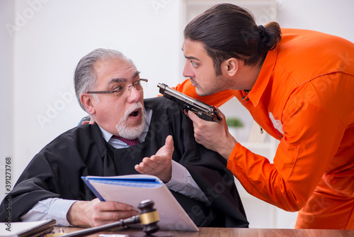 Fotografía Old male judge meeting with young captive in courthouse