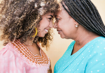 Beautiful african mother and adult daughter with forehead together - Mother and child love