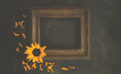 © eskstock - Old wooden frame with autumn flowers and leaves on brown rustic wooden background. Autumn flowers composition with copy space.