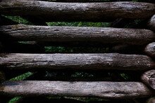 Close Up Of Vertical Dark Wooden Logs 
