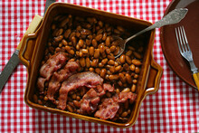 Meal Of Bacon And Beans On Baking Pan And Spoon