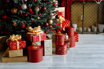 Gifts and gifts under the Christmas tree, winter holiday concept. Christmas gifts in a beautiful red package.