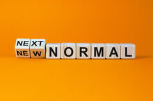 Turned Cubes And Changed The Words 'new Normal' To 'next Normal'. Covid-19 Postpandemic Concept. Beautiful Orange Background, Copy Space.