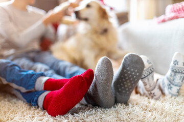 Wall Mural - Family in Warm Socks Sitting in a Cosy Christmas Atmosphere at Home