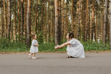 mother and little daughter 2 years old, playing together in the Park. happy motherhood