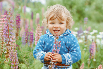 a child plays among the grass