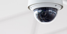 Closeup Of White Dome Type Cctv Digital Security Camera Installed On Ceiling For Observation.