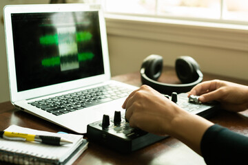 Making digital music at home and editing with a midi, computer. Creative work.
