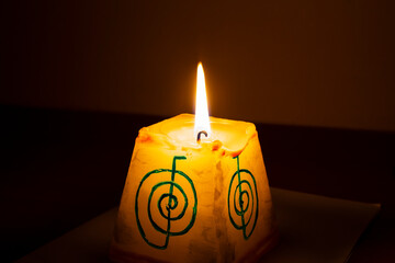 burning candle in the dark