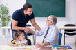 © Elnur - Young parent, old male teacher and little girl in the classroom