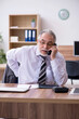 © Elnur - Old male employee suffering from radiculitis at workplace