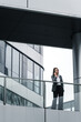 © JIACHUAN LIU/Stocksy - Businesswoman using cell phone In Office Buildings