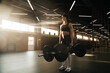 © Yakov Knyazev/Stocksy - Crossfit athlete - young beautiful woman doing deadlifts with a trap multi grip bar