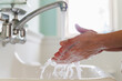 © jamie grill photography/Stocksy - Washing hands