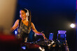 © Tadeu Dreyer/Stocksy - Young DJ woman playing music at a party