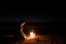 Night Campfire By A River - Young Woman Warming Hands