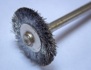 Steel brush used with rotary tools to clean metal surfaces