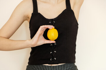 young millennial woman with lemon in her hands chooses vegetarianism