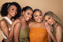 Studio Portrait Of Four Happy Beautiful Black Female Friends