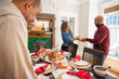 © Lynsey Weatherspoon/Creative Flame - Black multigenerational family setting table for Thanksgiving  holiday meal