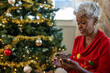 © Lynsey Weatherspoon/Creative Flame - Grandmother on smartphone reading holiday text messages
