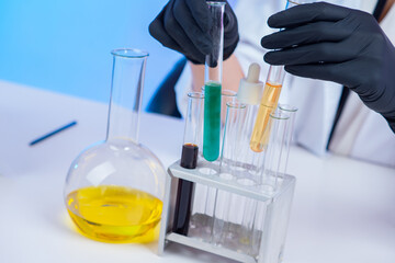 Poster - a man with test tubes in his hands. hands of a laboratory assistant close-up. flasks with chemicals 