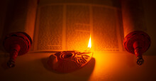 Ancient Lamp Illuminating The Hebrew Text Of The Torah