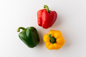 Colorful raw red yellow green of bell pepper above view on isolated white background. Healthy vegetables and food.