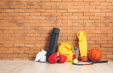 Wall Mural - Set of sport equipment on floor near brick wall