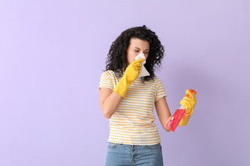 Allergic woman with detergent on color background