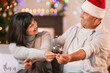 © Pixel-Shot - Mature couple with sparklers celebrating Christmas at home