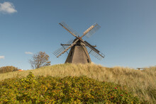 Old Windmill In A Field Under The Sunlight And A Blue Sky In Denmark