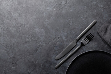 Wall Mural - Kitchen table with empty plate, fork, knife and towel