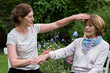 © Mint Images - Reiki therapist with a client in a therapy session touching meridian points on the body.