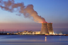 Riverbank With Nuclear Power Plant Doel During A Colorful Sunset, Port Of Antwerp, Belgium