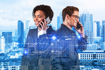 Businessman and businesswoman as a part of corporate team processing conference call to achieve tremendous growth in commerce using new technological approaches. Tech hologram icons over Kuala Lumpur