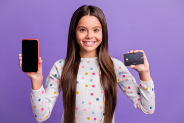 Canvas Print - Photo portrait of girl holding plastic card phone with blank space isolated on bright purple colored background