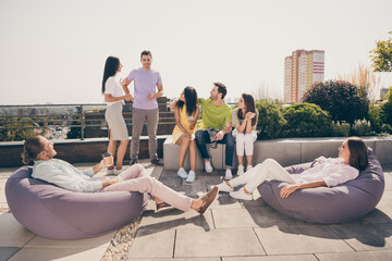 Poster - Full body photo of crowd of positive friends communicating tell to each other sit of soft chair meeting balcony outside