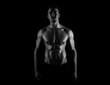 © Anetta - Muscular male torso of fit bodybuilder on black background in black and white