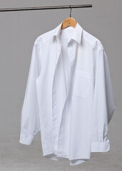 A white shirt on a coat hanger.