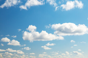 Poster - Blue sky background with white fluffy clouds in the fresh sunny day.